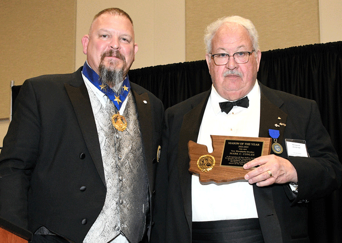 Grand Master Ed Woods presenting VW Mark Conlee with his Mason of the Year for 2022-2023 award at the Grand Master's Banquet.