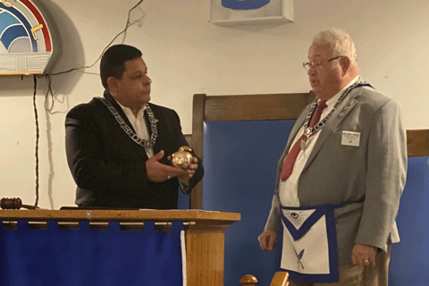 WB Mark Conlee presenting the Golden Apple award to WM Jamal Anglin who received it in the name of Phoenix Lodge.